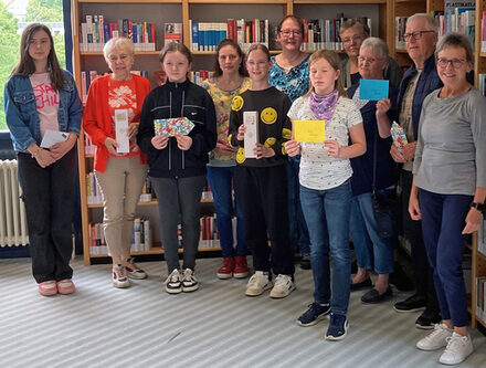 Die Gewinnerinnen und Gewinner der Cityrallye sowie Petra Stürmer von der Wohnbau (hinten Mitte) und Sylvia Fiedler, Leiterin der Stadtbibliothek (rechts).